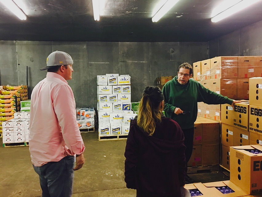 Mr. Rinella holding a meeting with our salespeople in the warehouse, highlighting new deals on eggs and produce.